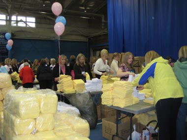 Thousands of women take part in service by assembling hygiene, newborn and school kits at the 2008 Women's Conference held at Brigham Young University in Provo, Utah.